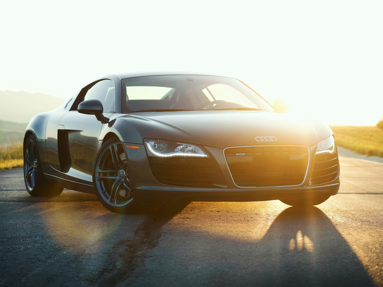Grey Audi R8 V10 photographed on an open road at sunset